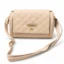 Beige quilted bag with gold-tone chain detail and adjustable strap
